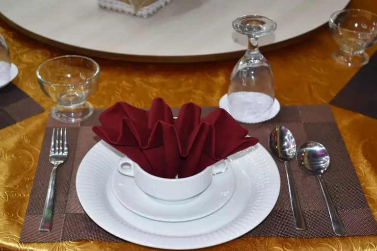 When setting a table, why should you hold glasses by the stem and cutlery from the middle